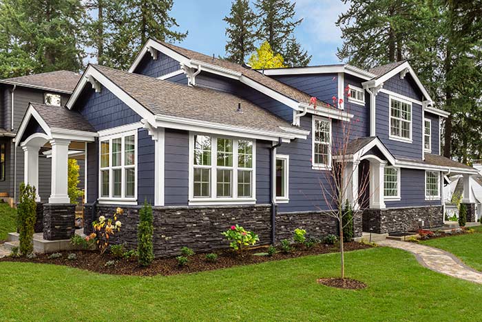 blue house with beautiful yard