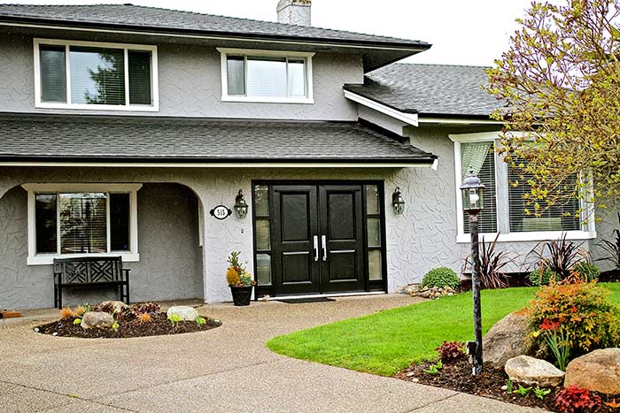 grey home with black doors and roof