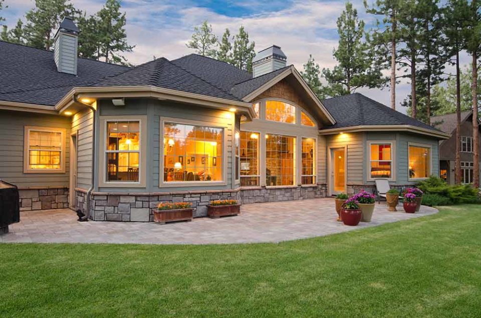 home with glowing windows at twilight